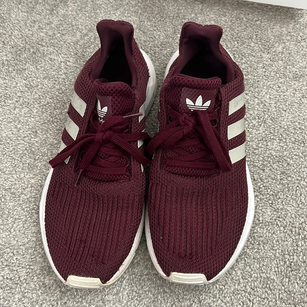 Maroon and white adidas sneakers